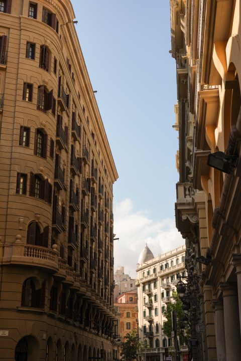 Warm light falling across a narrow street lined with tall buildings