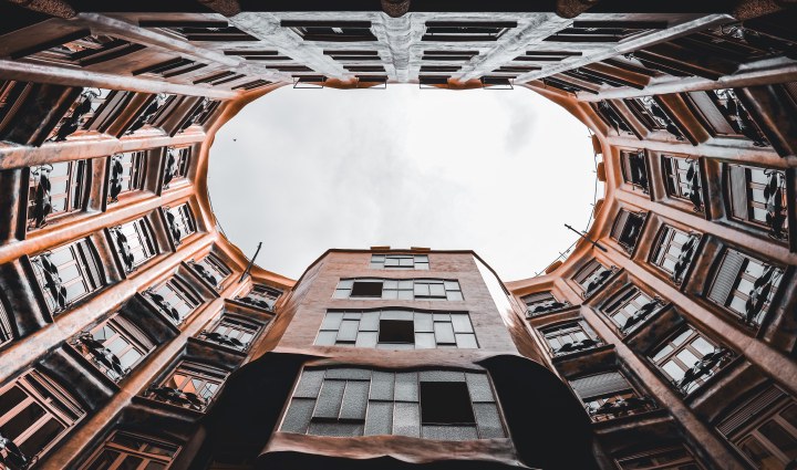 Looking upward through a courtyard framed by curved balconies