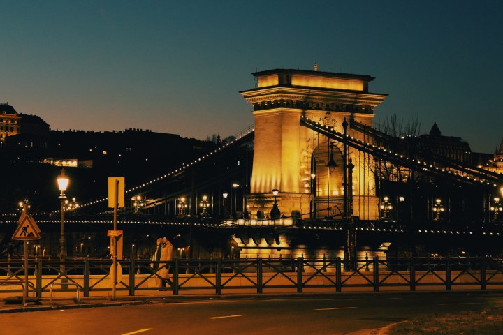 A warmly illuminated suspension bridge at night